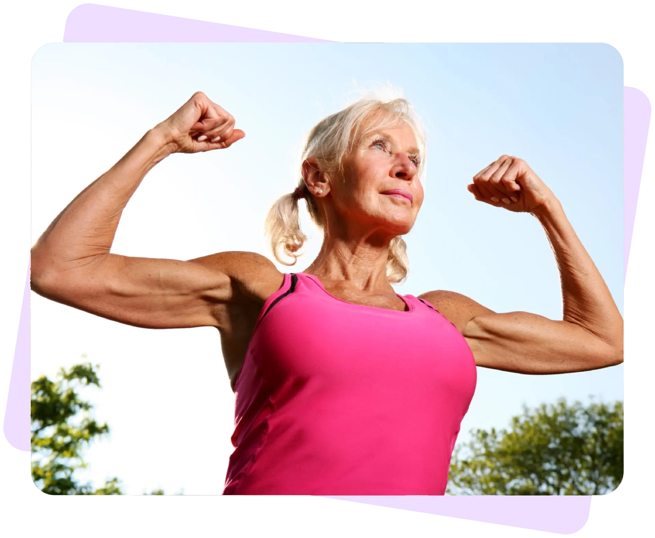 Elderly woman flexing muscles, wearing pink tank.